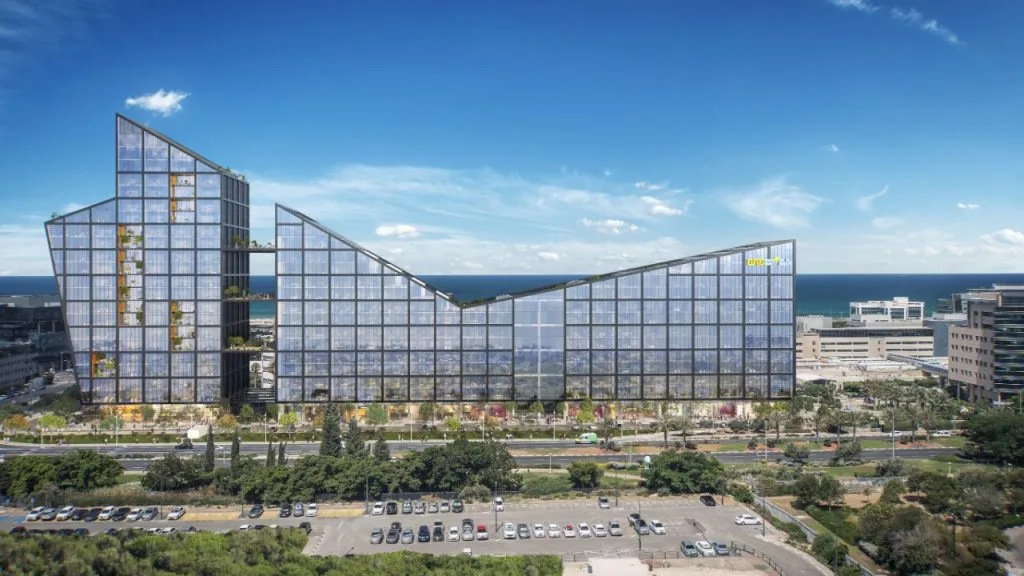 Aerial view of the building and its stepped glass masses by the sea