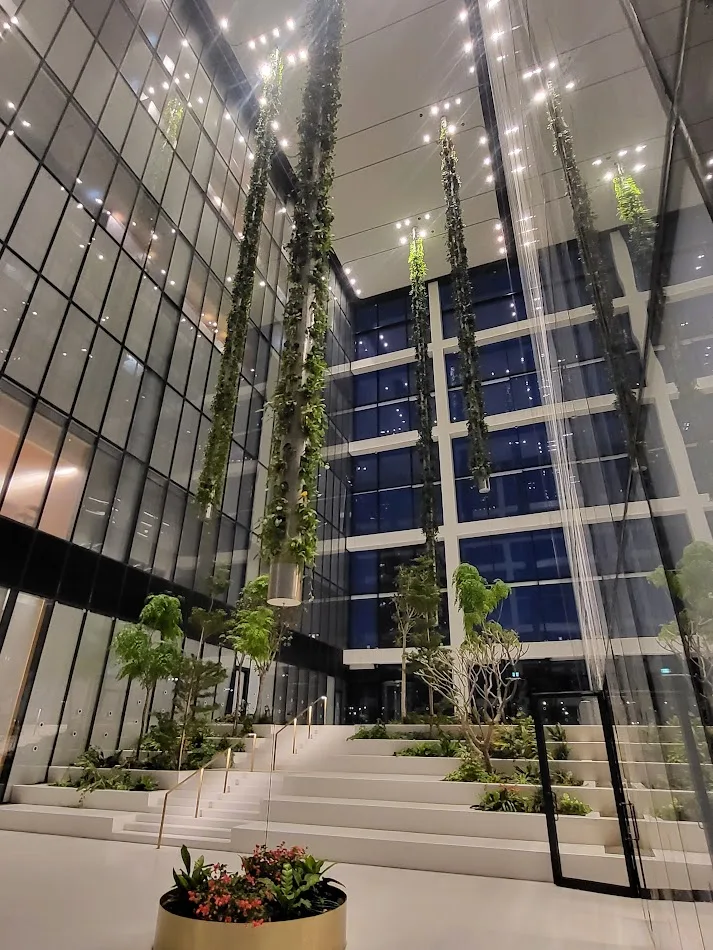 The double-height main lobby with hanging vertical gardens