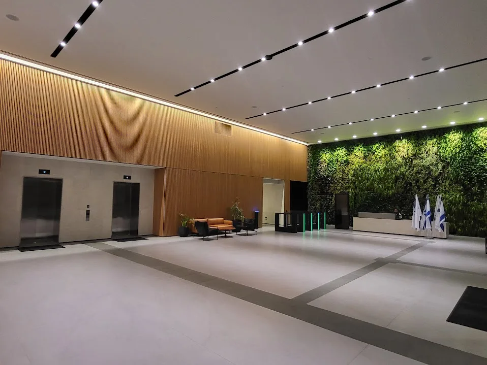 The reception lobby with a timber wall and a green living wall