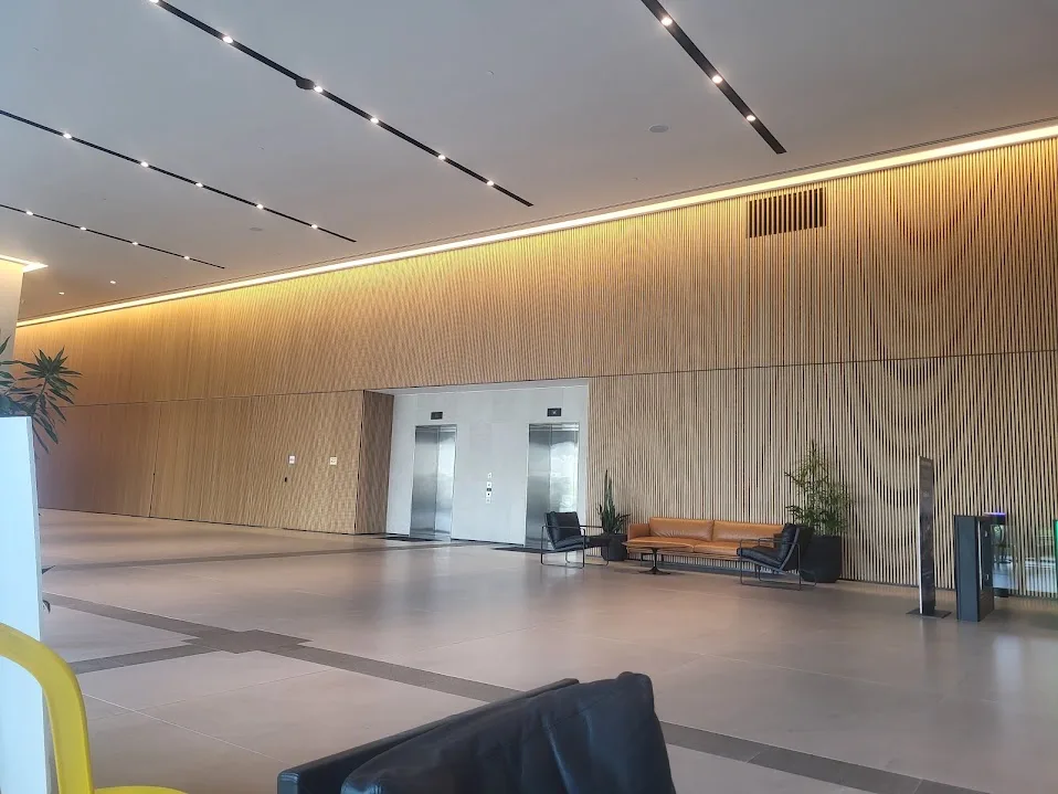 A typical floor lobby with timber walls and linear lighting