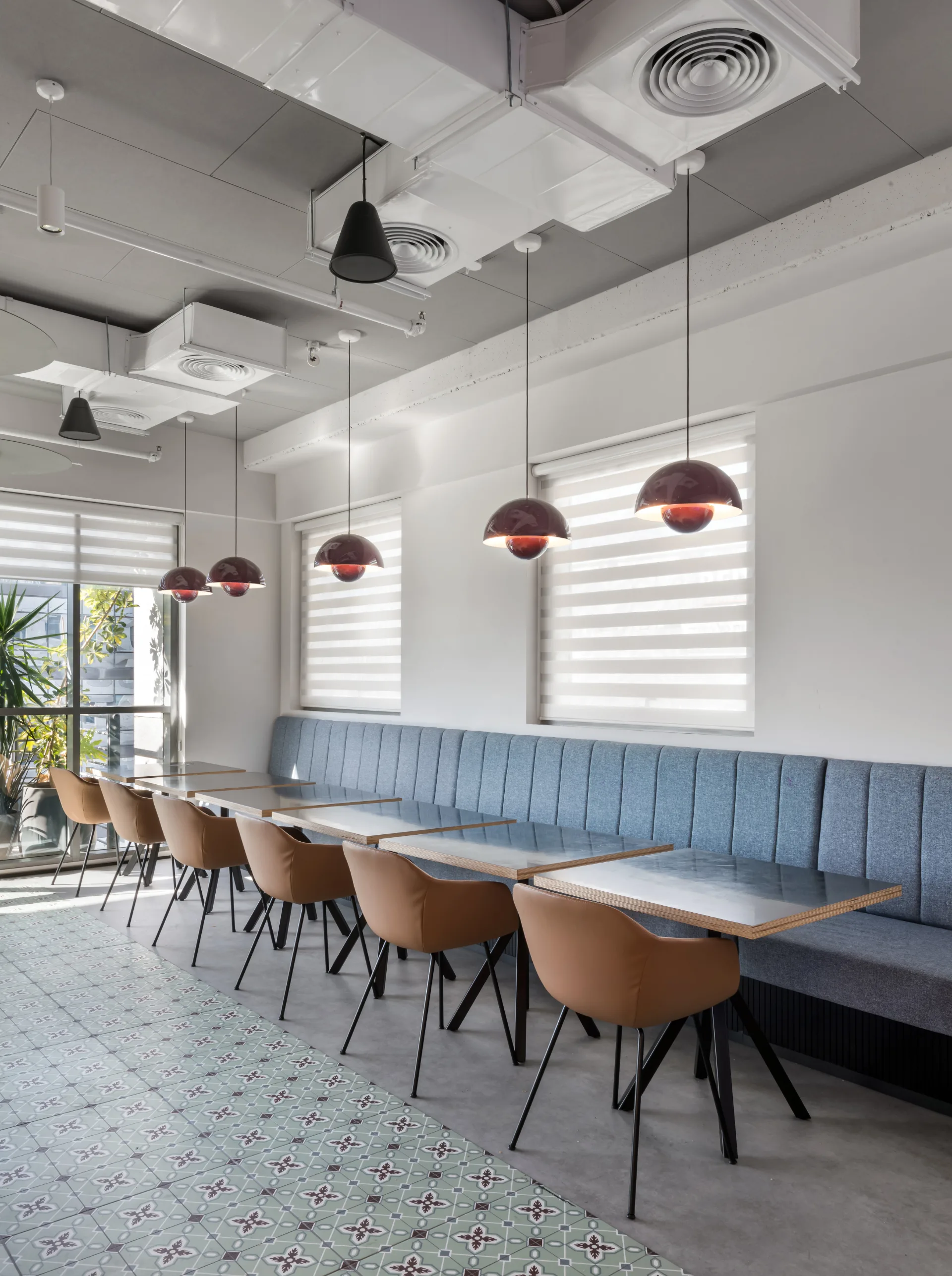 Dining area with an upholstered banquette and pendants