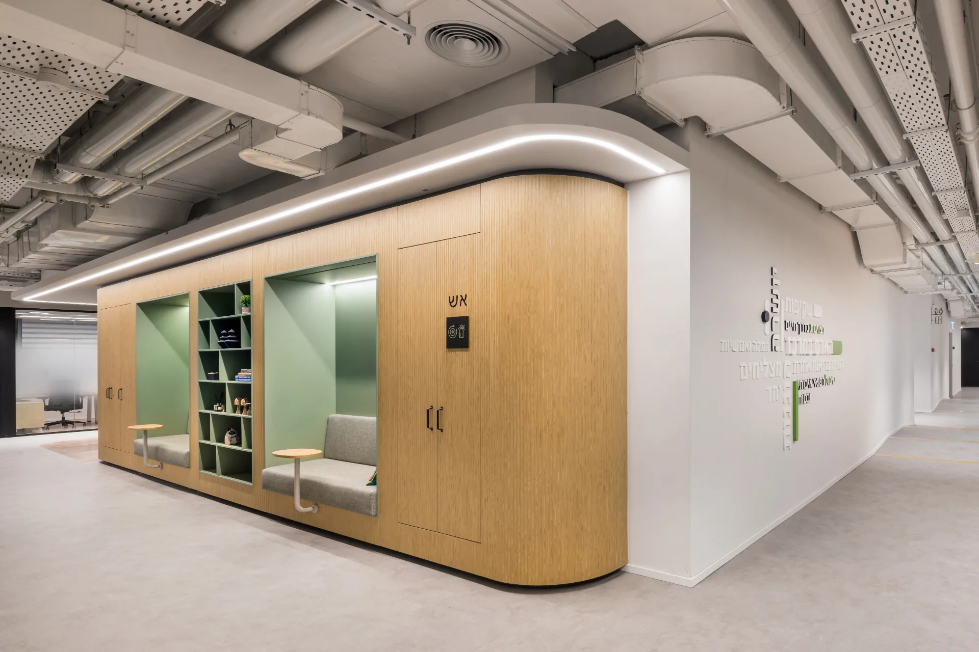 Green seating niches in timber joinery along the corridor