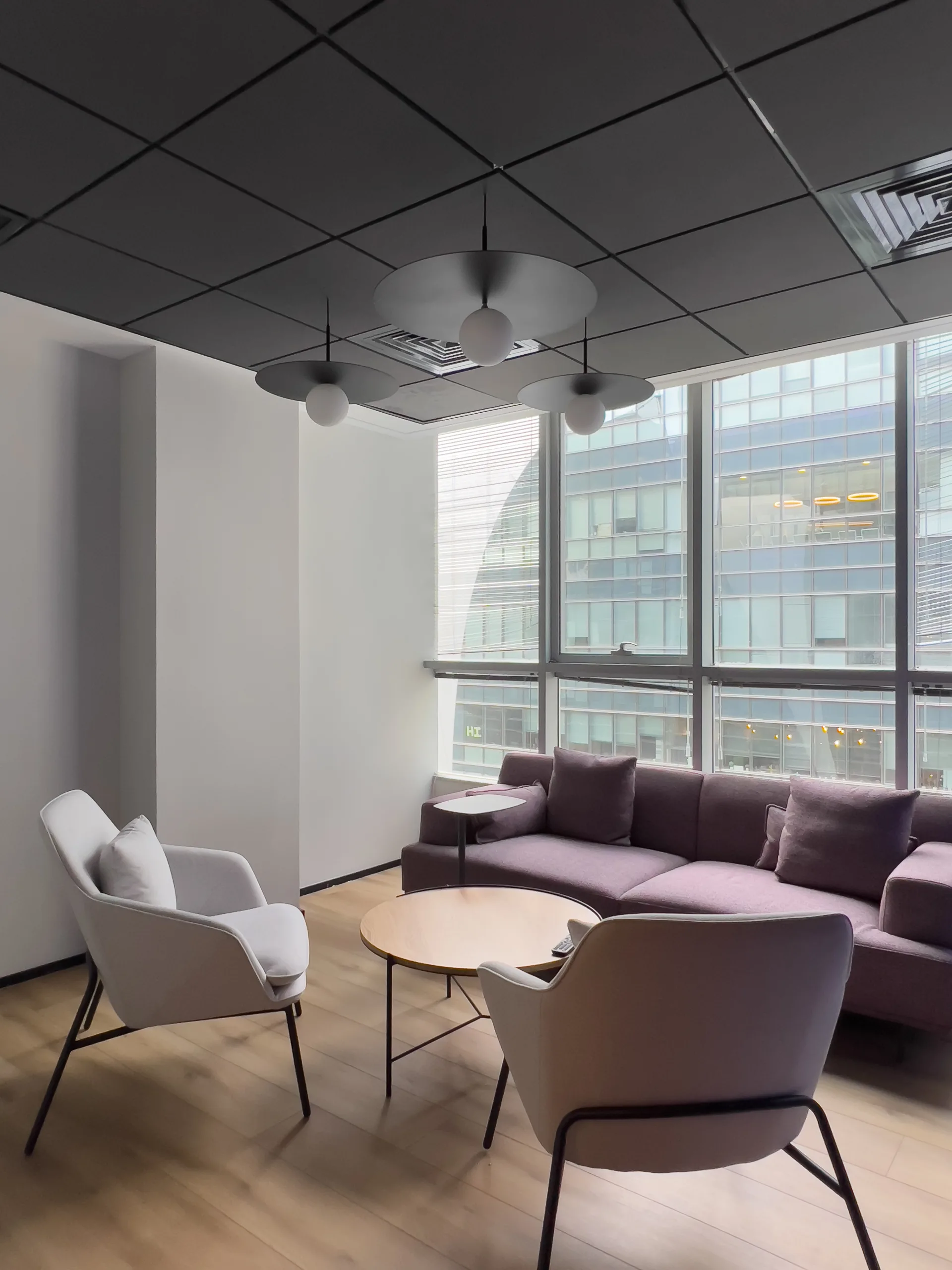 Lounge with pendant fixtures against a black ceiling