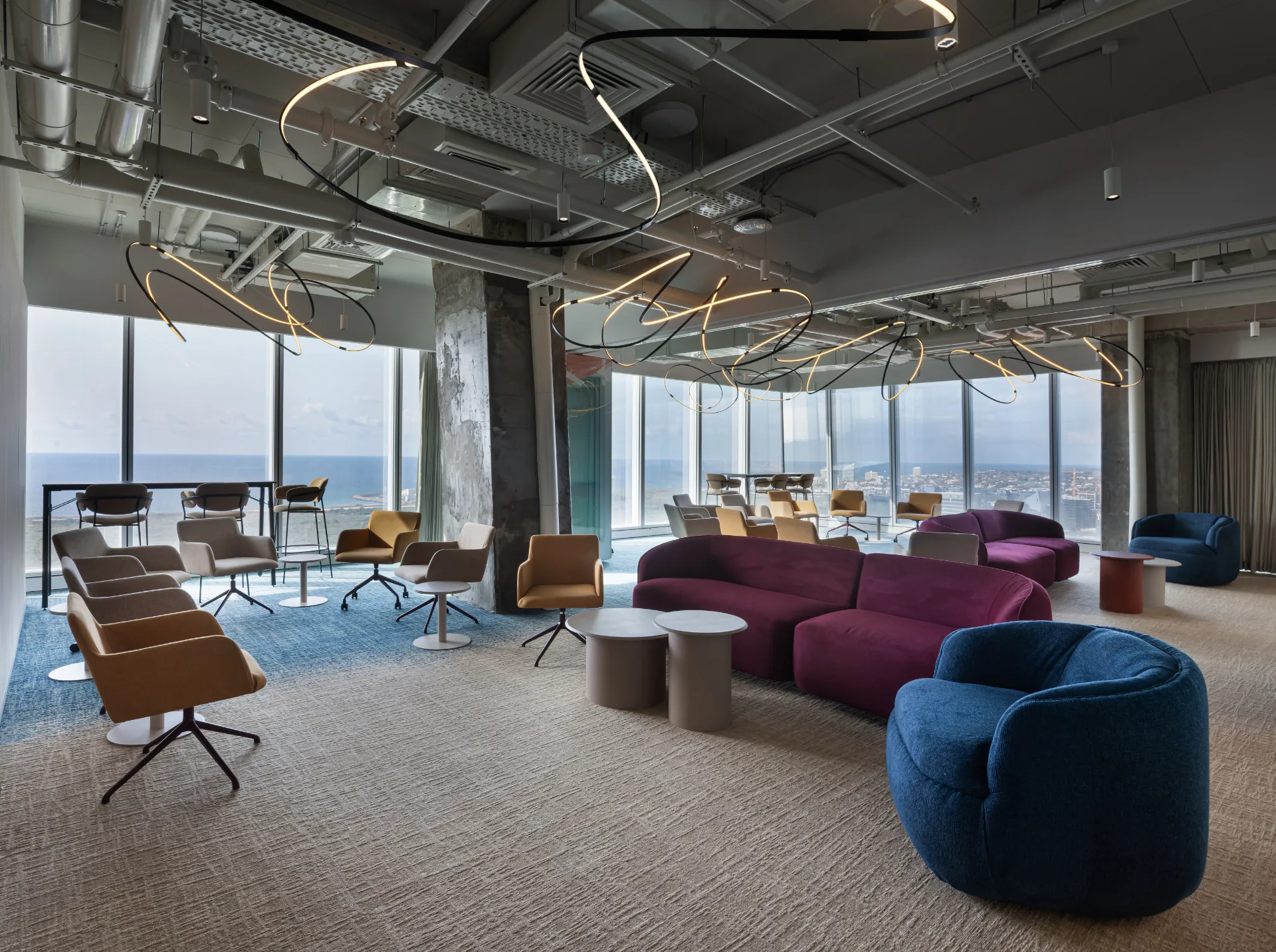 Social floor with winding light sculptures facing the sea