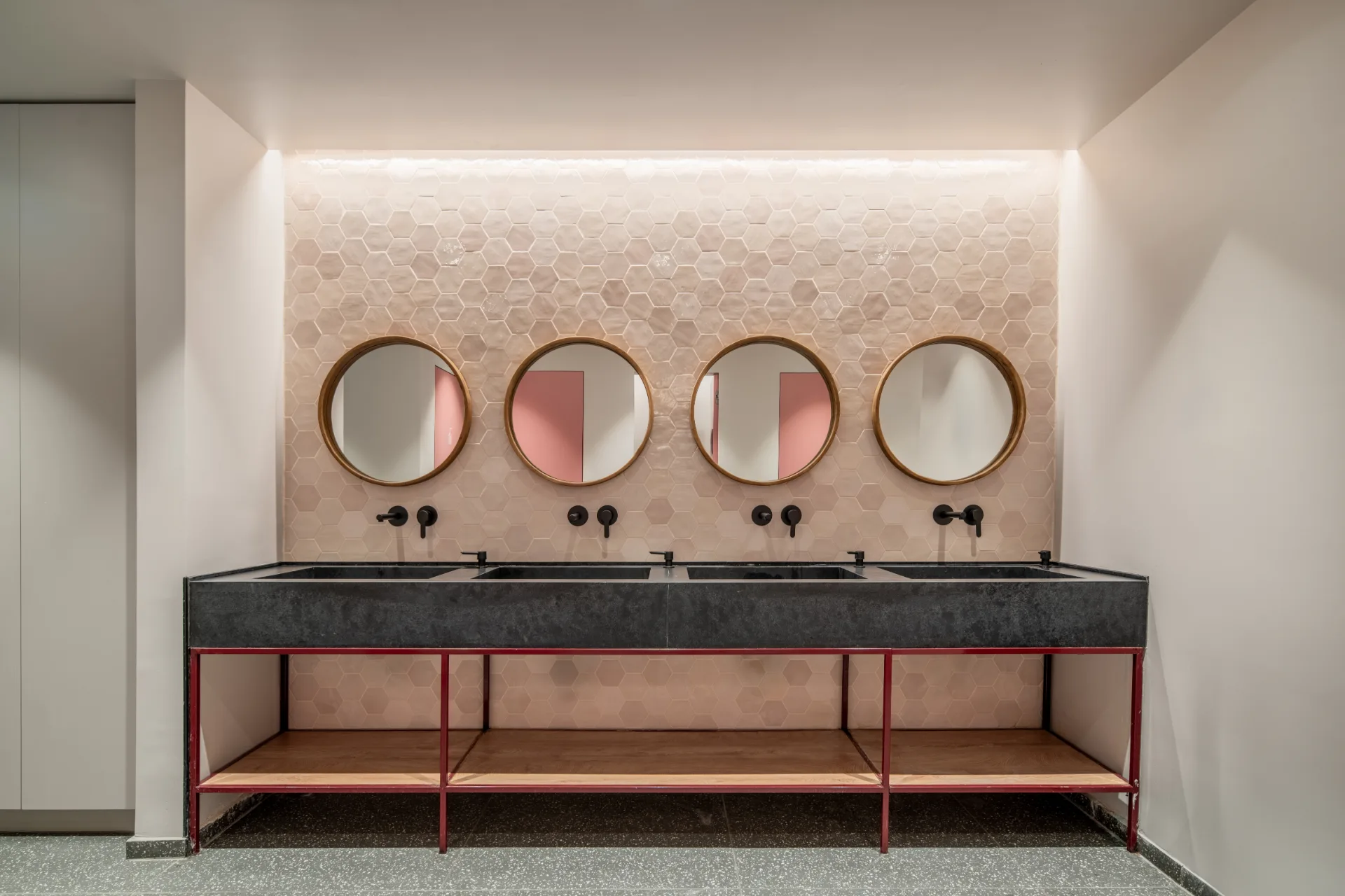 Washroom with round mirrors and concealed lighting