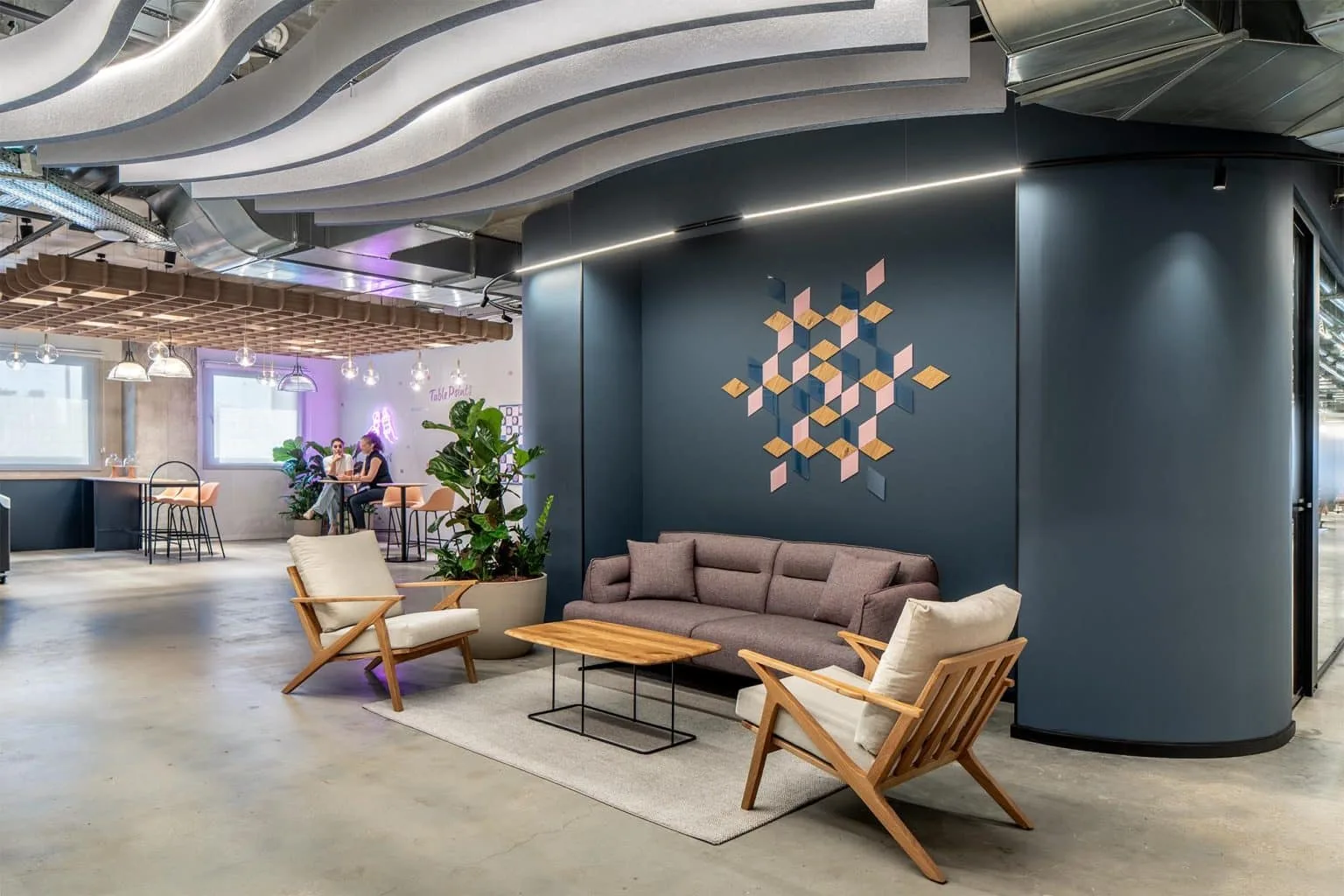 Lounge with architectural lighting at StarkWare offices